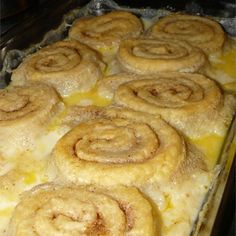 there are many cinnamon rolls on the baking sheet