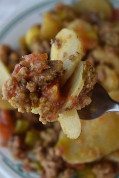 a spoon full of food on top of a plate