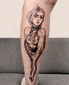 a woman's leg with a tattoo on it that has chains around her ankles