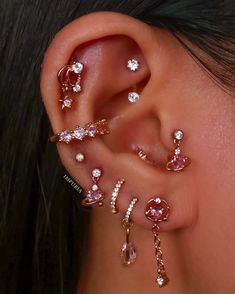 a close up of a person's ear with several different types of piercings