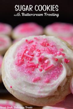 Sugar cookie with white buttercream frosting and pink sprinkles on top, with a cooling rack lined with other decorated sugar cookies in the background. Sugar Cookie Buttercream Frosting, Sugar Cookies With Buttercream Frosting, Cookies With Buttercream Frosting, Mini Lemon Cheesecakes, Easy Buttercream Frosting, Bite Size Cookies, Best Cookies Ever, Dessert Spread, Chewy Sugar Cookies