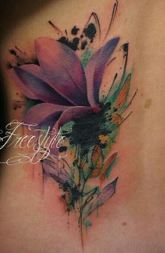 a woman's lower back tattoo with flowers on it