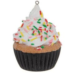 a cupcake with white frosting and sprinkles on top is hanging from a chain