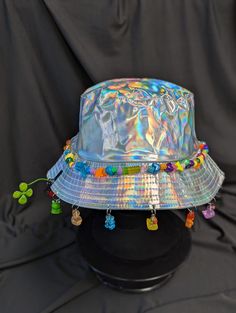 -hat color - silver -bead color - rainbow -charm color - rainbow -unisex adult size -inner circumference - 22.5in -crown dip - 3in -brim - 2.25in -NOT machine washable -Perfect for raves and outdoor festivals! Shipping within the US USPS First Class Package 3-9 days USPS Priority Mail 1-5 days USPS Priority Mail Express 1-3 days Shipping International  USPS First Class Mail International  -Varies- USPS Priority Mail International 6-14 days USPS Priority Mail Express International 3-9 days Shipping times are estimated, NOT GUARENTEED.  +International buyers are responsible for all import fees+ +Orders of $50+ may require signature confirmation upon delivery+ Adjustable Silver Beach Hat, Multicolor Hat For Carnival Festival, Multicolor Festival Hat For Carnival, Handmade Adjustable Silver Hats, Fun Adjustable Hat For Carnival, Adjustable Rave Hats For Festivals, Adjustable Silver Hat As Gift, Adjustable Multicolor Novelty Hat, Bohemian Silver Hat For Festivals