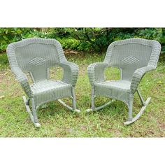 two grey wicker chairs sitting in the grass