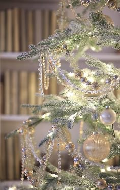 a white christmas tree with ornaments and lights