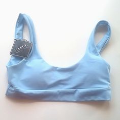 Small Sz4 Light Blue Sports Bra Bust 13" Lying Flat Sporty Light Blue Swimwear For Active Use, Sporty Light Blue Swimwear For Sports, Blue Seamless Activewear For Spring, Spring Blue Seamless Activewear, Casual Blue Sports Swimwear, Sporty Blue Swimwear With Bra-friendly Design, Sporty Blue Swimwear Bra-friendly, Sporty Blue Swimwear With Bra Friendly Design, Sporty Bra-friendly Blue Swimwear