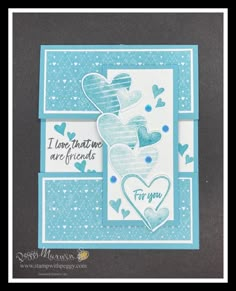 a card with some hearts on it and the words i love you written in blue