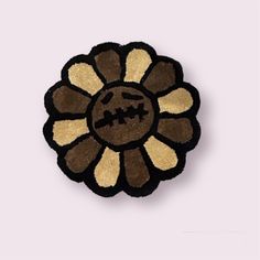 a brown and black flower with two faces on it