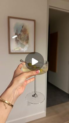 a person holding a wine glass in their hand