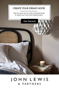 a bed with white sheets and pillows in front of a light that reads, create your dream home