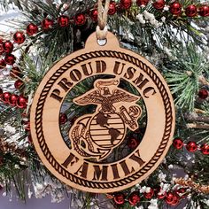 an ornament hanging from a christmas tree with the words proud us navy family