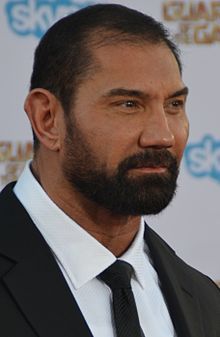 a man with a beard wearing a suit and tie