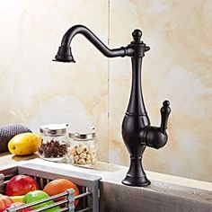 a kitchen faucet with various fruits and nuts in the bottom drawer under it