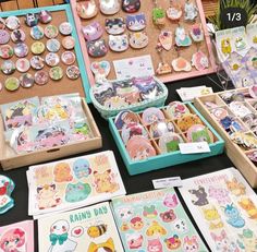 there are many different items on display in the box and behind them is an assortment of stickers