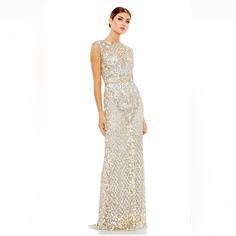 Full Length Gown With Sequins, Jeweled Tasseled Sleeves, And Faux Belt. Mac Duggal Hand-Embellished Mesh Overlay; 100% Polyester Lining Partially Lined Bodice; Fully Lined Skirt; Semi-Sheer Unlined Sleeves Illusion High Neckline Beaded Fringe Cap Sleeves All-Over Intricate Floral And Baroque Detailing Sequined Lattice Pattern Featured On Skirt And Neckline Paillette Sequined Waist Detail Sweeping Train Concealed Back Zipper Approx. 62.5" From Top Of Shoulder To Bottom Hem Available In Platinum G Elegant Sleeveless Maxi Dress For Reception, Champagne Embellished Sleeveless Gown, Champagne Sleeveless Sequin Gown, Elegant Sleeveless Evening Dress For Reception, Sleeveless Sequin Evening Dress For Reception, Gold Sleeveless Reception Dress, Elegant Sleeveless Reception Dress, Embellished Sleeveless Evening Dress For Reception, Mac Duggal Dress