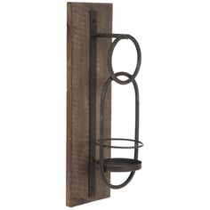 an iron and wood wall mounted candle holder