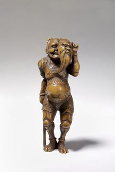 an old bronze figurine with a man holding his head