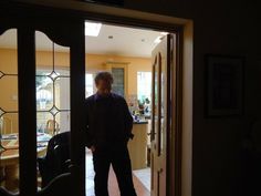 a man standing in the doorway of a house