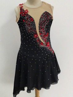 a dress on a mannequin with red flowers and sequins in the back