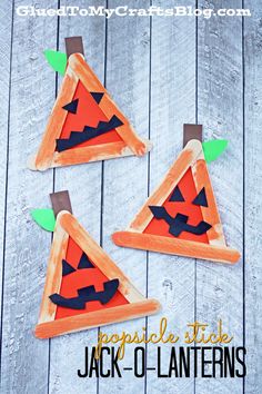 three popsicle stick jack - o'- lanternes made with construction paper and glue