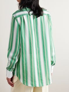 Wales Bonner's 'Cadence' shirt is striped with rows of green and beige stripes that fade into one another. Cut for a relaxed fit, it has a contrasting poplin grandad collar and cuffs and buttoned flap pockets, one is embroidered with the brand's initials. Spring Green Shirt With Vertical Stripes, Green Vertical Stripes Shirt For Spring, Green Tops With Striped Collar For Work, Green Top With Striped Collar For Work, Green Vertical Striped Shirt For Summer, Green Shirt With Striped Collar For Summer, Green Vertical Striped Summer Shirt, Green Cotton Tops With Signature Stripes, Green Tops With Striped Collar And Relaxed Fit