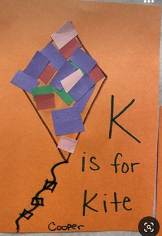 a piece of paper with the words k is for kite on it and an orange background