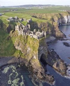 an aerial view of a castle near the ocean