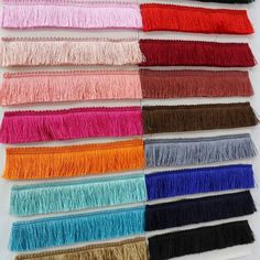 several colors of tassels are arranged in rows