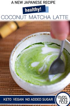 a person is spooning into a green matcha latte in a white bowl