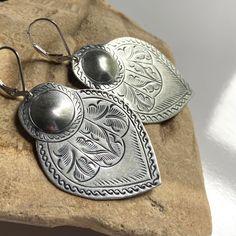 "Unique, large and lightweight, these Moroccan-style hand-stamped dangle earrings will be your new favorite pair. If you want a pair of signature statement earrings that won't wear you down, you found them!  * Each pear-shaped medium-sized pendant is about 1 5/8\" long x 1 1/8\" wide at the widest point. * Earring backs are high-quality sterling silver (.925) French loop or lever back ear wire.  * Stamped pendants are vintage, hand-etched by the Hill Tribe in Thailand. Sterling silver ear wires Bohemian Silver Hand Stamped Jewelry, Silver Bohemian Hand Stamped Jewelry, Silver Hand-stamped Bohemian Jewelry, Silver Teardrop Stamped Jewelry, Silver Hand Stamped Earrings For Gift, Hand Stamped Silver Bohemian Jewelry, Nickel Free Silver Southwestern Earrings, Bohemian Stamped Earrings, Vintage Sterling Silver Etched Earrings