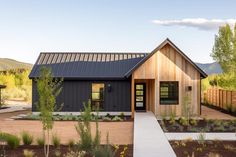 this is a rendering of a modern house in the country side with landscaping and trees