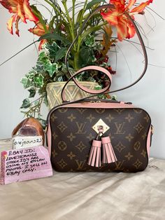 Louis Vuitton Monogram Saintonge with Rose Ballerine Pink This little shoulder/crossbody bag is perfectly sized! Measurements are 8.5" x 5.57" x 3" with a 22.5" drop.  Listing includes: LV Saintonge shoulder bag only. This adorable little bag has pink leather trim, shoulder strap, a pop up top handle and a pink front tassel.  The top zipper opens to pink fabric interior with a patch pocket.  Please supersize the photos as they are the best description of condition. The bag is in excellent preowned condition. There is slight creasing on the pink leather part of the bag. This is a preowned item. There are no major flaws, but since it is preowned, I find it easiest to say you may find slight creasing on the leather including the strap, possible corner rubbing, signs of use such as scuffing or Pink Monogram Canvas Rectangular Shoulder Bag, Pink Rectangular Monogram Canvas Shoulder Bag, Pink Crossbody Bag, Pink Fabric, Selling On Ebay, Pink Leather, Say You, Leather Trim, The Pink