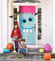 a magazine with an image of two children in front of a door and pumpkins on the steps