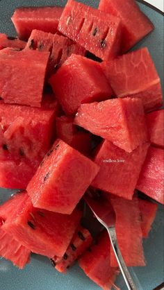 sliced watermelon on a plate with a spoon