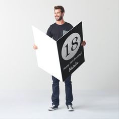 a man is holding up a sign with the number 44 on it