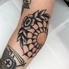 a black and white tattoo on the arm of a person's leg with an owl