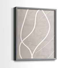 a gray and white painting hanging on the wall