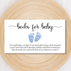 a sign that says books for baby on top of a wooden plate with a white background