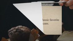 a person holding a piece of paper with the words classic favorite cans on it