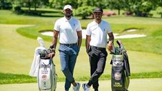 two men standing next to each other holding golf bags