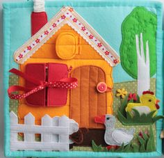 a close up of a small house made out of felt and paper with scissors on it