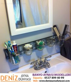 a bathroom sink with toothbrushes, combs and other items