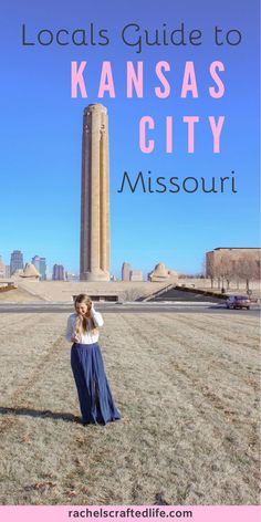 a woman standing in front of a tall tower with the words kansas city missouri on it