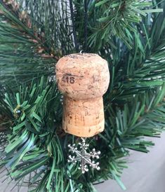 a wine cork ornament hanging from a christmas tree