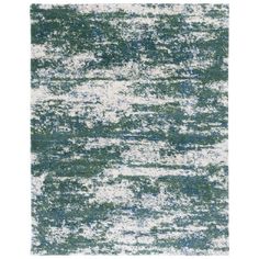 an area rug with green and white colors on the floor, in shades of blue