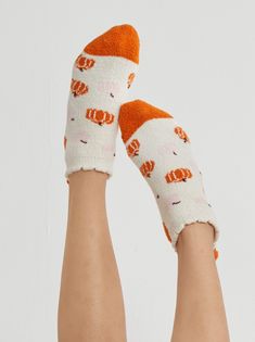 Fuzzy comfort meets polished style in Shiraleah’s Pumpkin Home Socks. These socks feature a fuzzy texture, pompom heel detail, and have a unique feminine flair with its fun all over pumpkin print in a ivory and orange color combination. These socks have a rubber grip bottom and are packaged ribbon wrapped making them the perfect gift option. Color: Ivory Fits Size 5-10 Polyester And Spandex; Rubber Grip Bottom Made In China Vegan Packaging: Ribbon 35-97-027Iv Vegan Packaging, Fall Trends 2023, Pumpkin Socks, Orange Color Combinations, Autumn Treats, Fall Socks, Halloween Socks, Fuzzy Texture, Polished Style