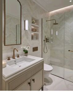 a bathroom with a sink, toilet and shower in it's own area is shown