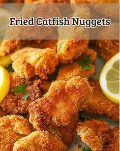 fried fish nuggets on a plate with lemons and parsley