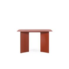 a red table sitting on top of a white floor